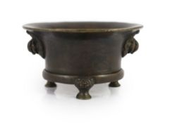 A Chinese bronze tripod censer, 18th century,cast with a pair of mythical beast mask handles, on