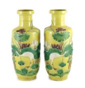 A pair of Chinese yellow ground ‘crane and lotus’ rouleau vases, Qianlong seal mark, early 20th