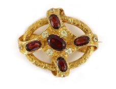 A Victorian engraved gold, chrysoberyl? and garnet set open work scroll brooch,44mm, gross weight 21