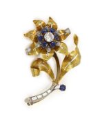 A textured gold, sapphire and diamond floral spray brooch,set with round cut sapphires and round and