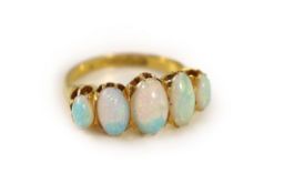 An Edwardian 18ct gold and five stone graduated white opal set half hoop ring,size L, gross 4.7