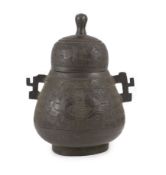 A Chinese bronze jar and cover, hu, 17th/18th century,cast in low relief with taotie masks and
