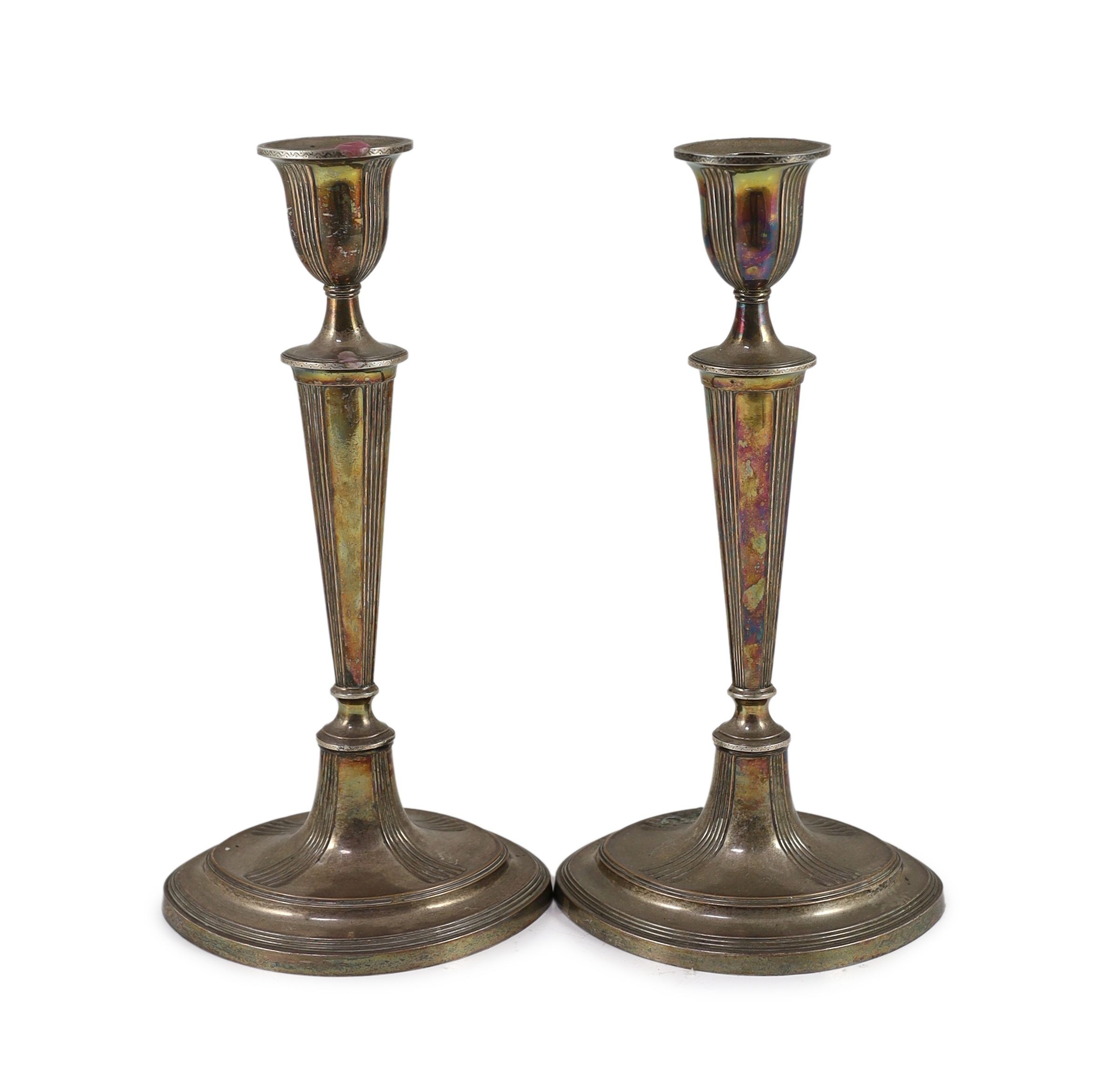A pair of Sheffield plate candlesticks and nozzles,of neo-classical elliptical form, the stems