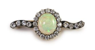 An early 20th century gold, white opal and diamond cluster set brooch,the central opal measuring