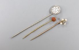 An Edwardian yellow metal, seed pearl and diamond set stick pin, 57mm and two other stick pins.