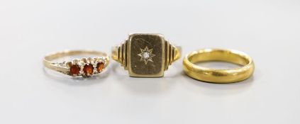 An early 1930's 22ct gold wedding band, size N/O, 7.1 grams and two 9ct gold rings including a mid