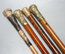 Four Victorian gilt-metal mounted walking canes, longest 97cm