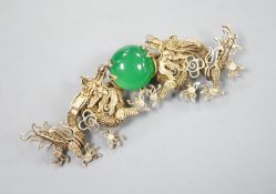 A Chinese gilt white metal and green cabochon stone set filligree dragon brooch, 88mm.