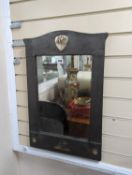 A Liberty style mother of pearl inlaid hammered pewter wall mirror with heart and snail motifs.