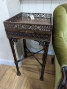 A pair of George III style square mahogany fret cut urn stands on cluster column legs, (one in
