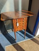 A Regency satinwood banded mahogany drop flap work table, width 69cm extended, depth 46cm, height