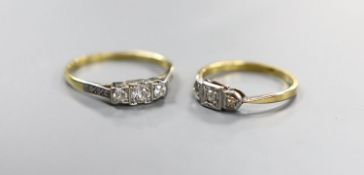 Two early 20th century yellow metal (one stamped 18ct & plat) and three stone diamond rings, one