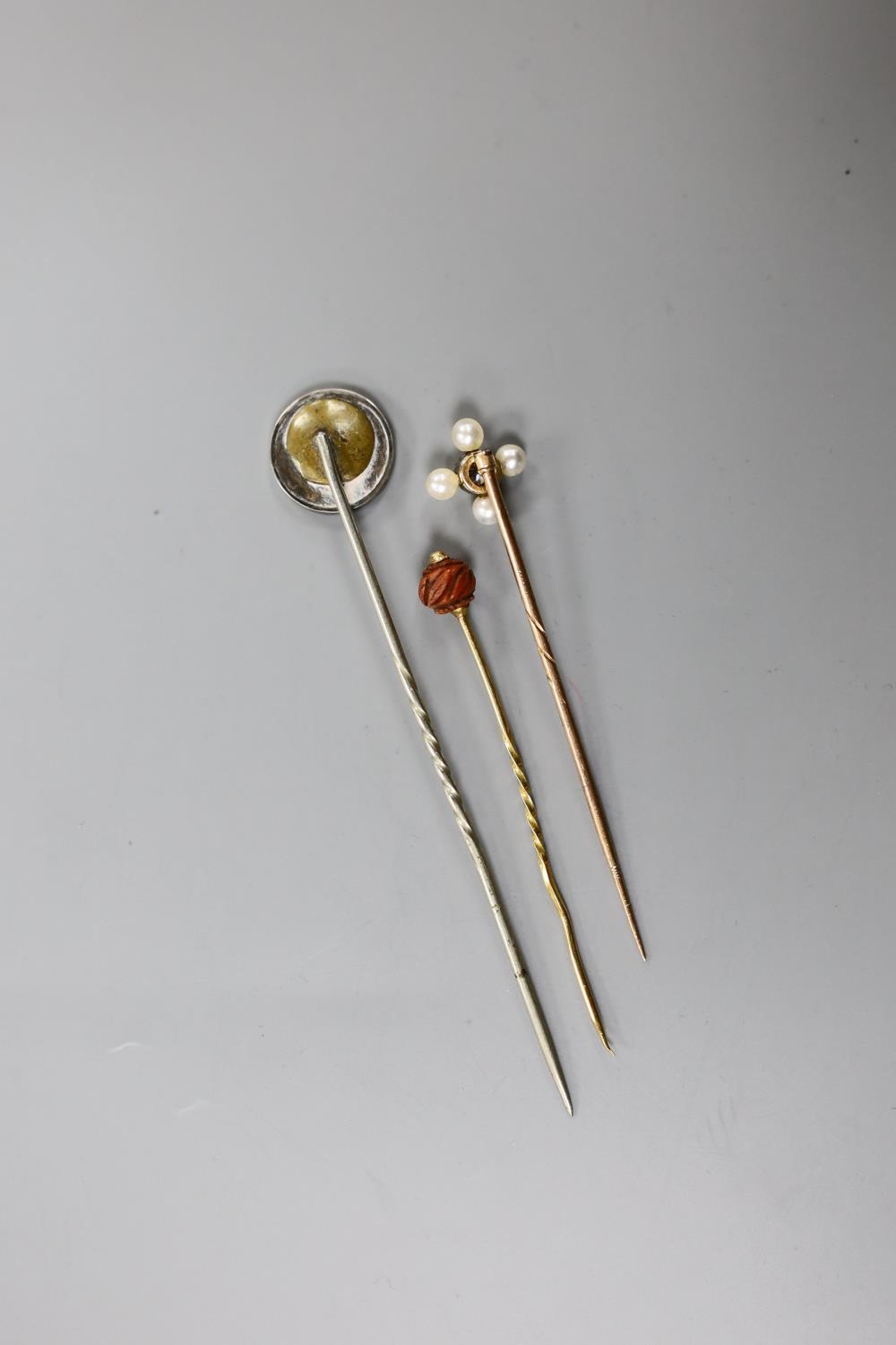 An Edwardian yellow metal, seed pearl and diamond set stick pin, 57mm and two other stick pins. - Image 5 of 5