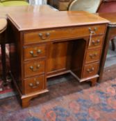 A reproduction George III style rosewood banded mahogany kneehole desk, length 88cm, depth 44cm,