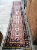 A Caucasian design brick red ground runner, 430 x 80cm