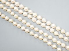 A modern long single strand cultured pearl necklace, with fluted 14k and diamond chip set clasp,