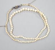 An Edwardian single strand graduated natural saltwater pearl necklace, with sapphire and diamond