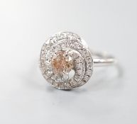 A French white metal( 18ct poincon mark) and cognac coloured single stone diamond ring, with diamond