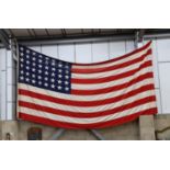 A large mid 20th century 'Stars and Stripes' American flag, approximately 460cm wide, height 240cm