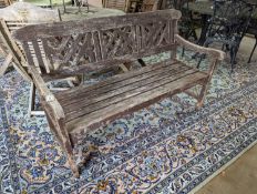 A weathered teak garden bench, length 146cm, depth 50cm, height 86cm