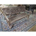 A weathered teak garden bench, length 146cm, depth 50cm, height 86cm