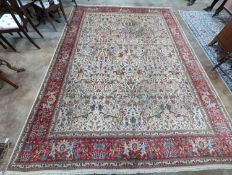 A Tabriz ivory ground pictorial rug (signed), 390 x 294cm