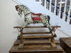 A small early 20th century Ayres type dapple grey rocking horse, length 106cm, height 87cm