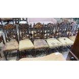 A set of fourteen 19th century Continental carved oak dining chairs
