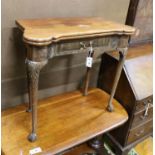 A George II mahogany folding card table on carved cabriole legs, width 76cm, depth 38cm, height