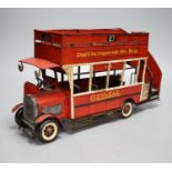 A reproduction tinplate double decker topless bus, the side reading ‘Don’t be vague - ask for Haig’,