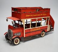 A reproduction tinplate double decker topless bus, the side reading ‘Don’t be vague - ask for Haig’,