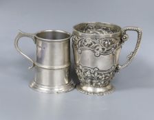 A late Victorian embossed silver christening mug, London, 1895, 10.5cm and a similar later silver
