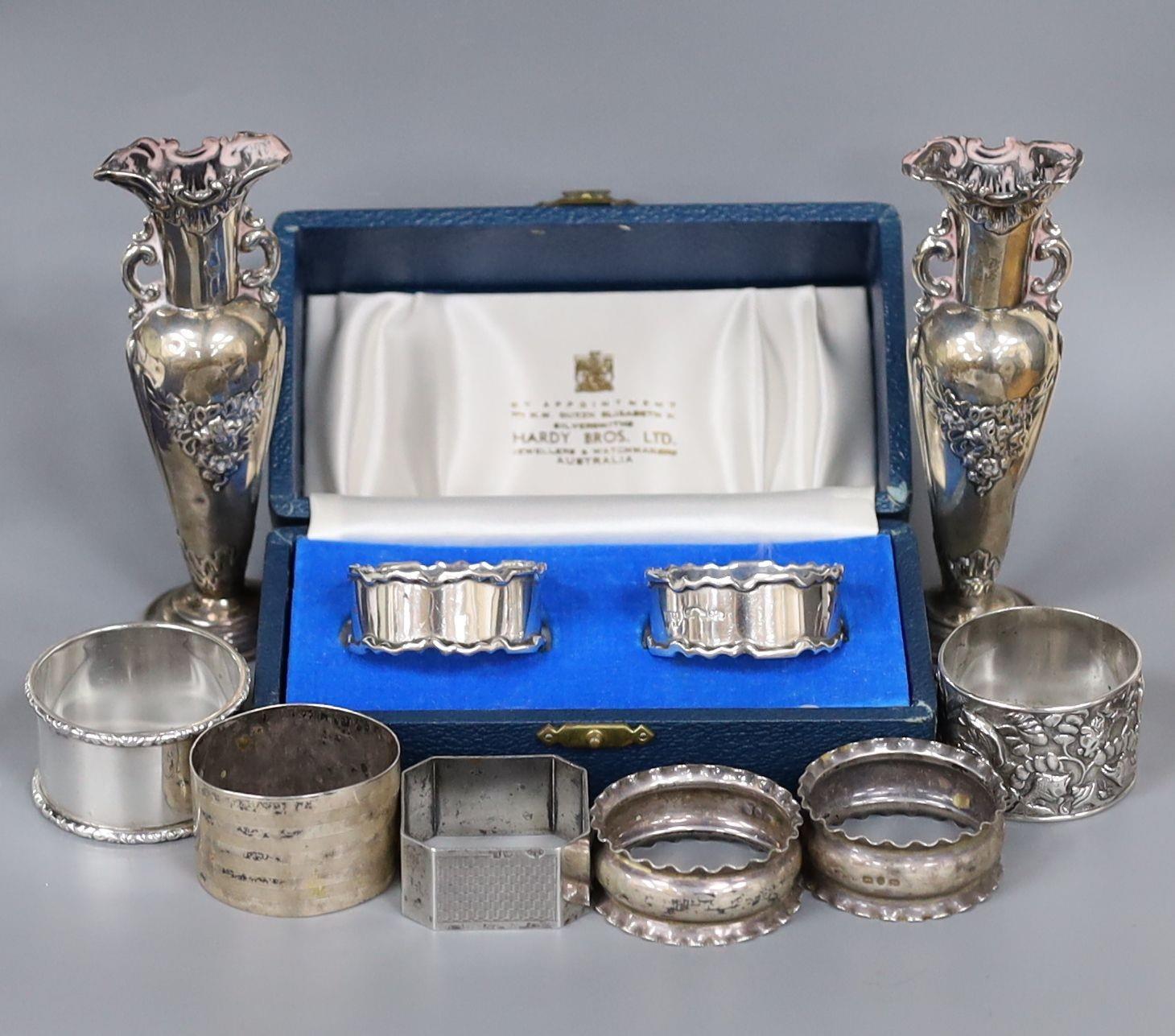 A cased pair of silver napkin rings, five others including one white metal and a two small silver