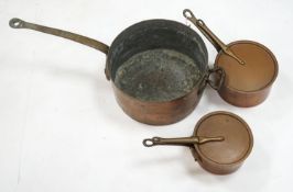 A group of three Victorian copper saucepans