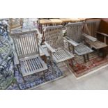 A set of six weathered teak folding garden armchairs and a low teak garden table