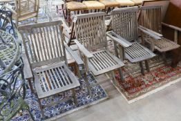 A set of six weathered teak folding garden armchairs and a low teak garden table