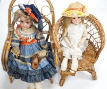 Two Armand Marseille 390 bisque dolls, each in wicker chair