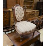 A small late Victorian carved walnut sewing chair, with buttoned back and turned legs, width 53cm,