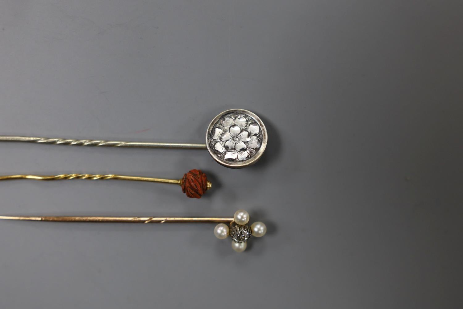 An Edwardian yellow metal, seed pearl and diamond set stick pin, 57mm and two other stick pins. - Image 4 of 5