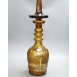 A large amber glass decanter and stopper, 74cm