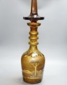 A large amber glass decanter and stopper, 74cm