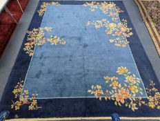 An early 20th century Art Deco Chinese blue ground floral carpet, 400 x 310cm