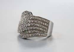 A modern 18ct white gold and pave set diamond dress ring, size O, gross 8.4 grams
