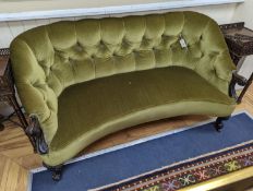 An early Victorian rosewood concave fronted two seat settee upholstered in buttoned green dralon,