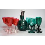 A Victorian dark green glass decanter, five dark green wine glasses and 6 cranberry bowled wine