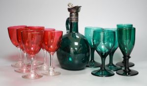 A Victorian dark green glass decanter, five dark green wine glasses and 6 cranberry bowled wine