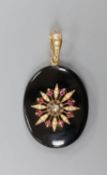 A Victorian black enamel, rose cut diamond, ruby coloured paste and seed pearl set oval mourning