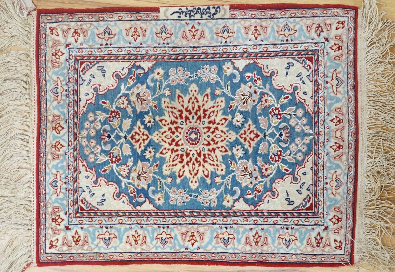 A north-west Persian blue-ground floor mat, signed, 42x53cm