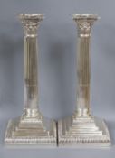 A pair of Edwardian silver Corinthian column candlesticks, Goldsmiths & Silversmiths Co Ltd, London,