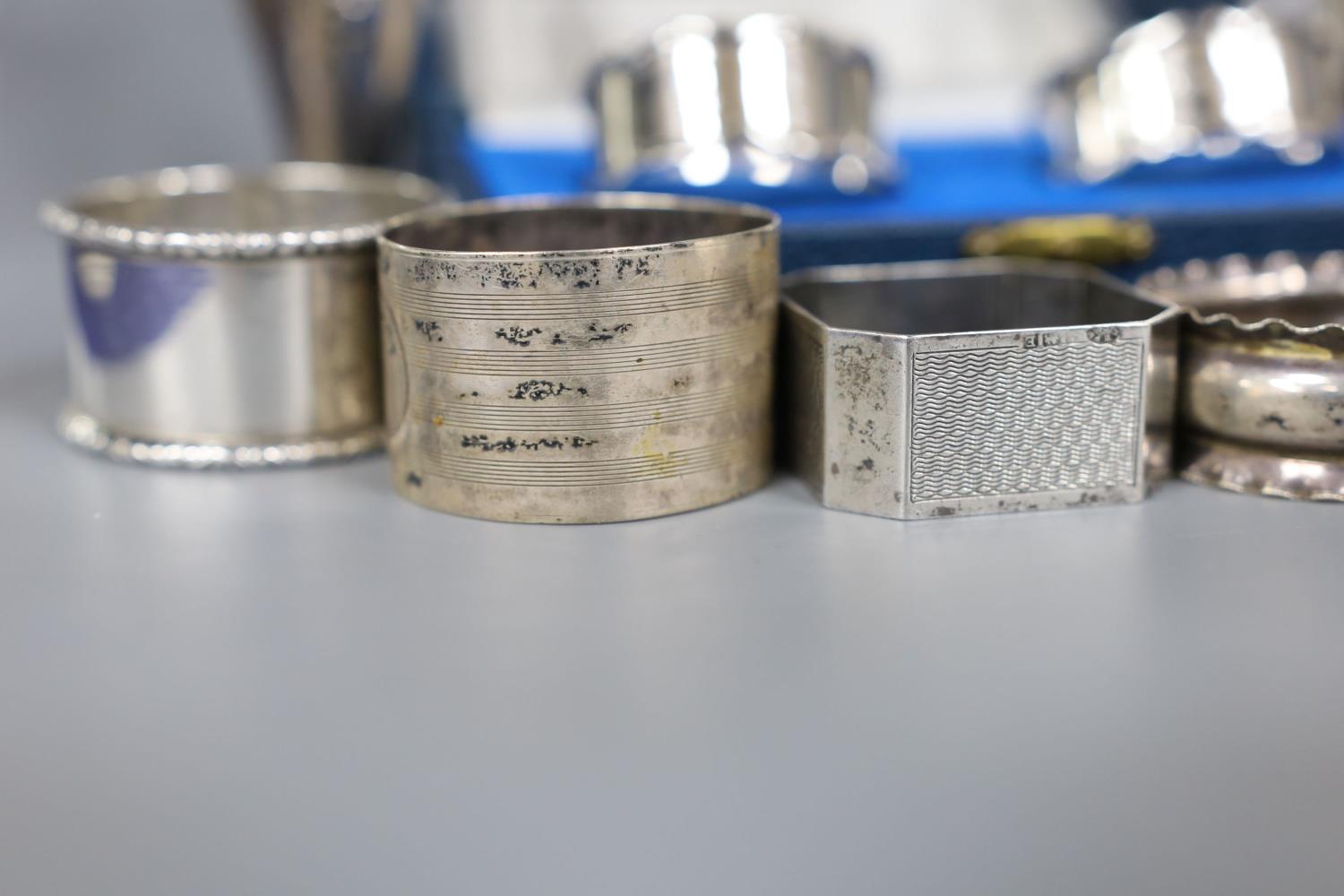 A cased pair of silver napkin rings, five others including one white metal and a two small silver - Image 2 of 4